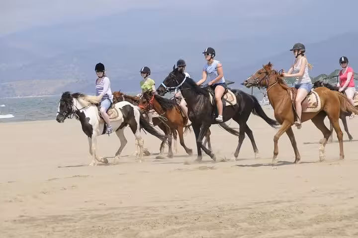 Group horseback riding on Kusadasi beach, part of Ephesus shore excursion from Kusadasi Port tour