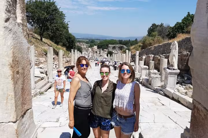 Travelers posing on Curetes Street in ancient Ephesus ruins, Kusadasi Port shore excursion tour stop