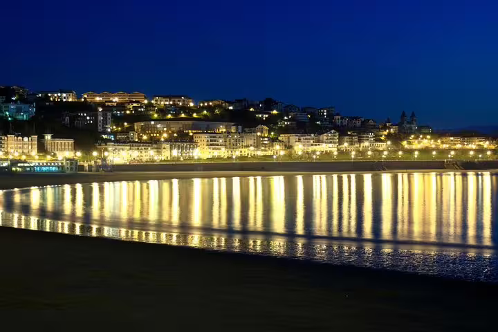 Night view of La Concha Bay lights in San Sebastián, a scenic stop on a self-paced e-scavenger hunt tour