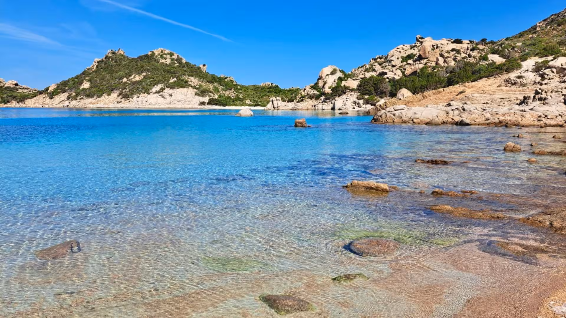 Clear blue waters and rocky landscapes of La Maddalena, showcasing the natural beauty for yacht tour enthusiasts.
