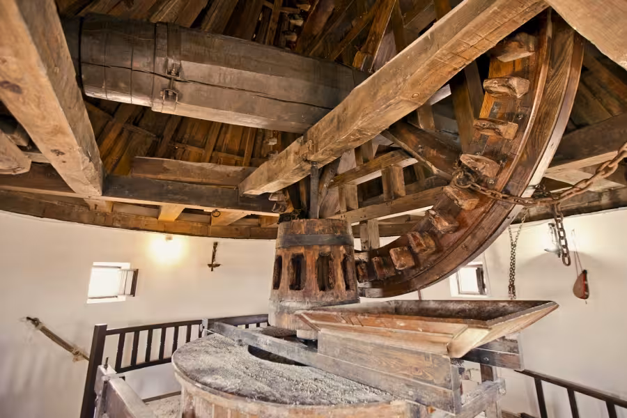 Inside a traditional La Mancha windmill machinery on the Don Quixote Tour, wooden gears and millstones