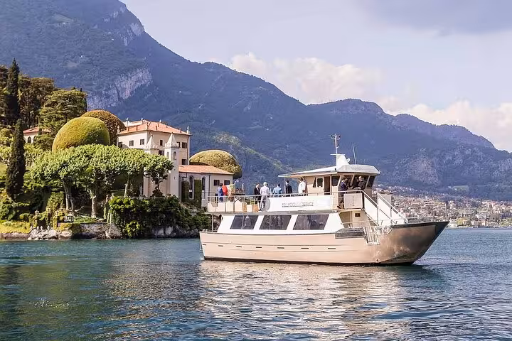Lake Como cruise boat near Bellagio villas and mountains, day trip tour from Lugano with scenic views