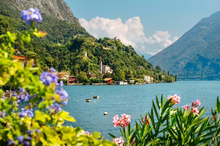 Colorful lakeside flowers and alpine village on Lake Lugano, highlight of Milan to Switzerland private day tour