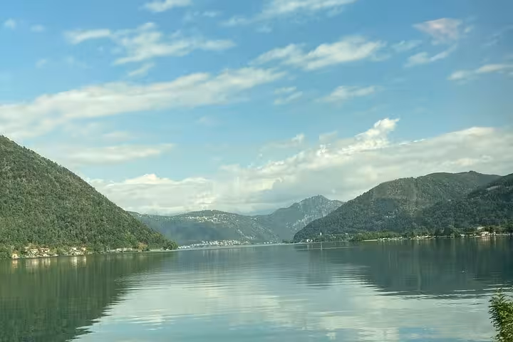 Panoramic Lake Lugano mountain reflections on the Lugano to Como Bellagio cruise plus train tour