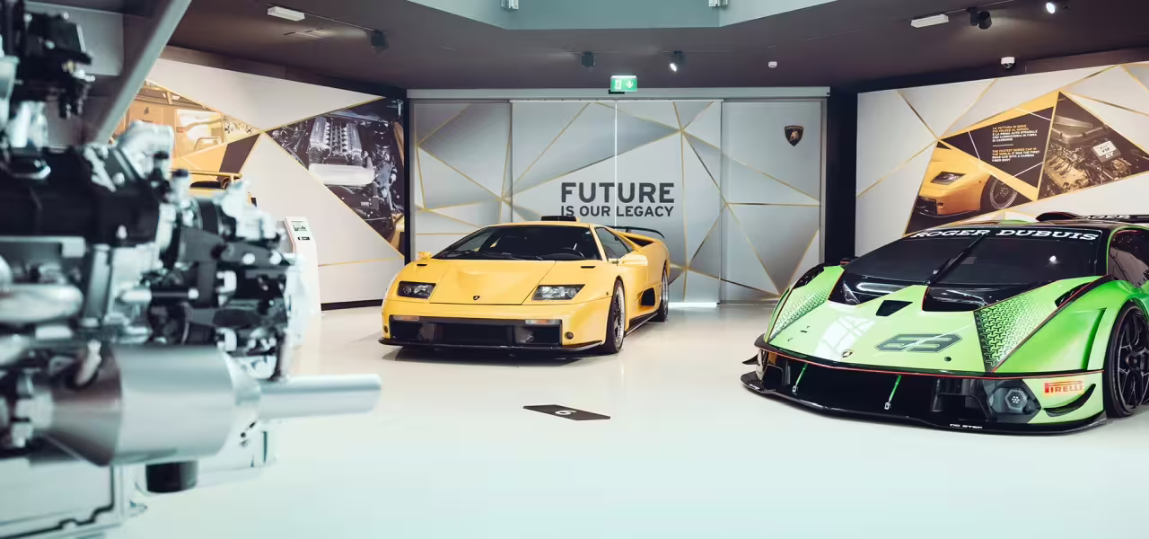 Explore Lamborghini's legacy with a yellow Diablo and a green racing car at the Bologna museum.