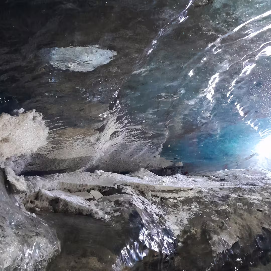 entrance area of the natural ice cave at Langjöjull glacier with blue hues