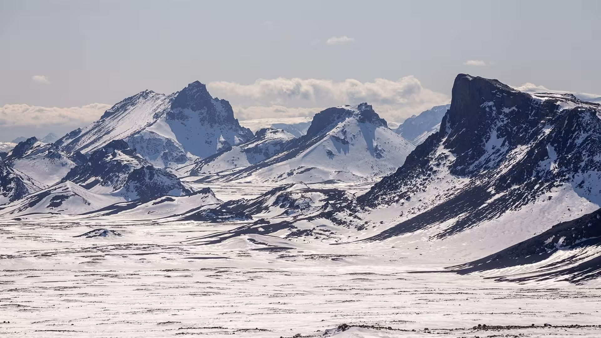 Panoramic Langjokull glacier highlands from Gullfoss, rugged snow-covered peaks on ice cave tour route