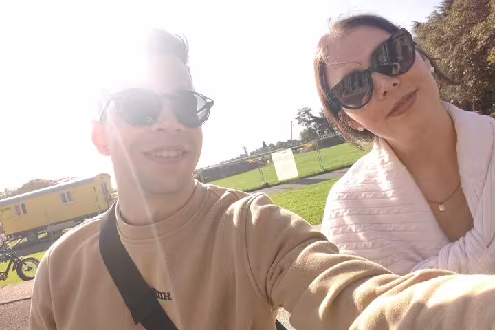 Couple selfie on Lausanne city center scavenger hunt and sights self-guided tour, sunny day in Switzerland