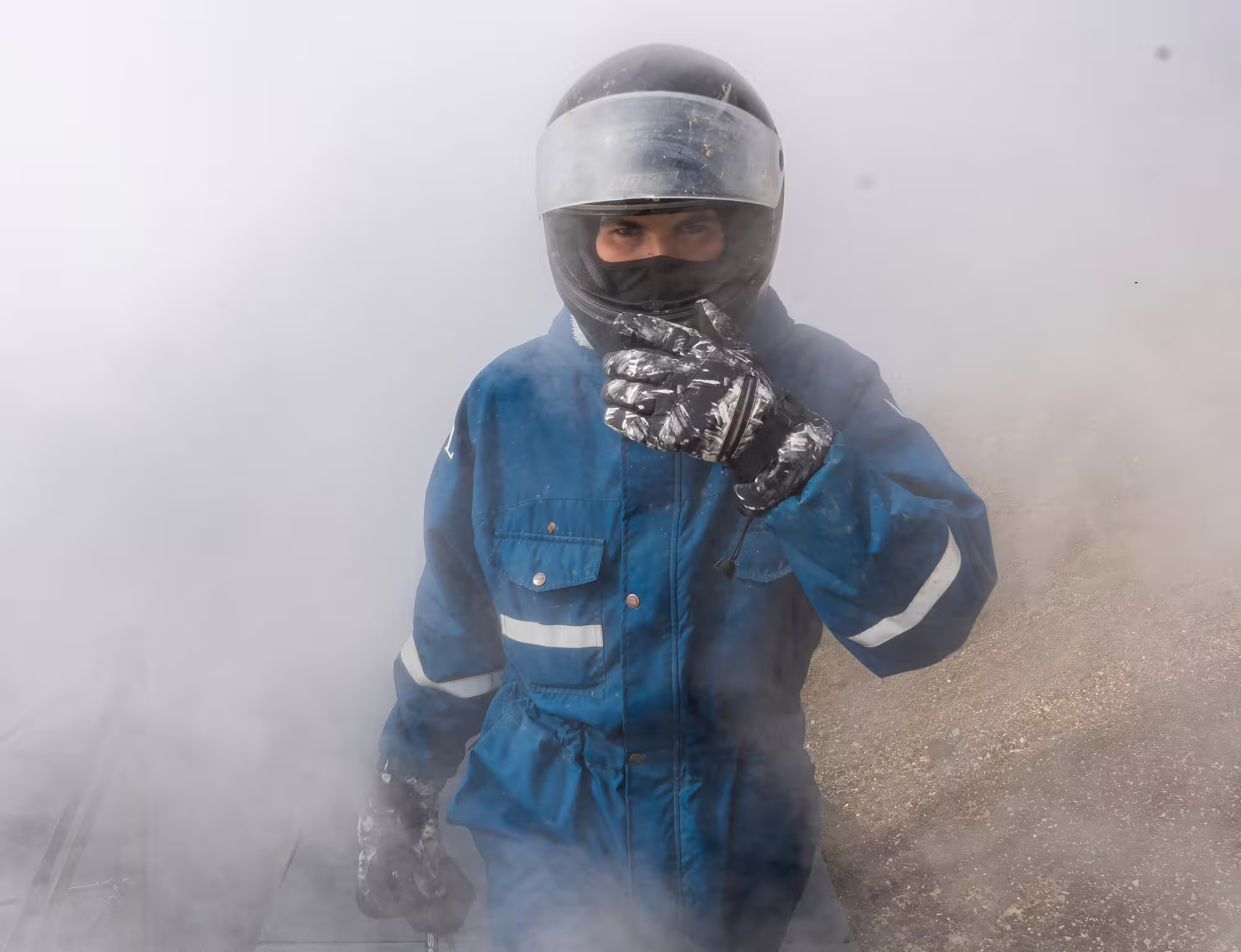 Adventurer in protective gear explores misty volcanic landscape on a thrilling 2-hour lava field buggy tour.
