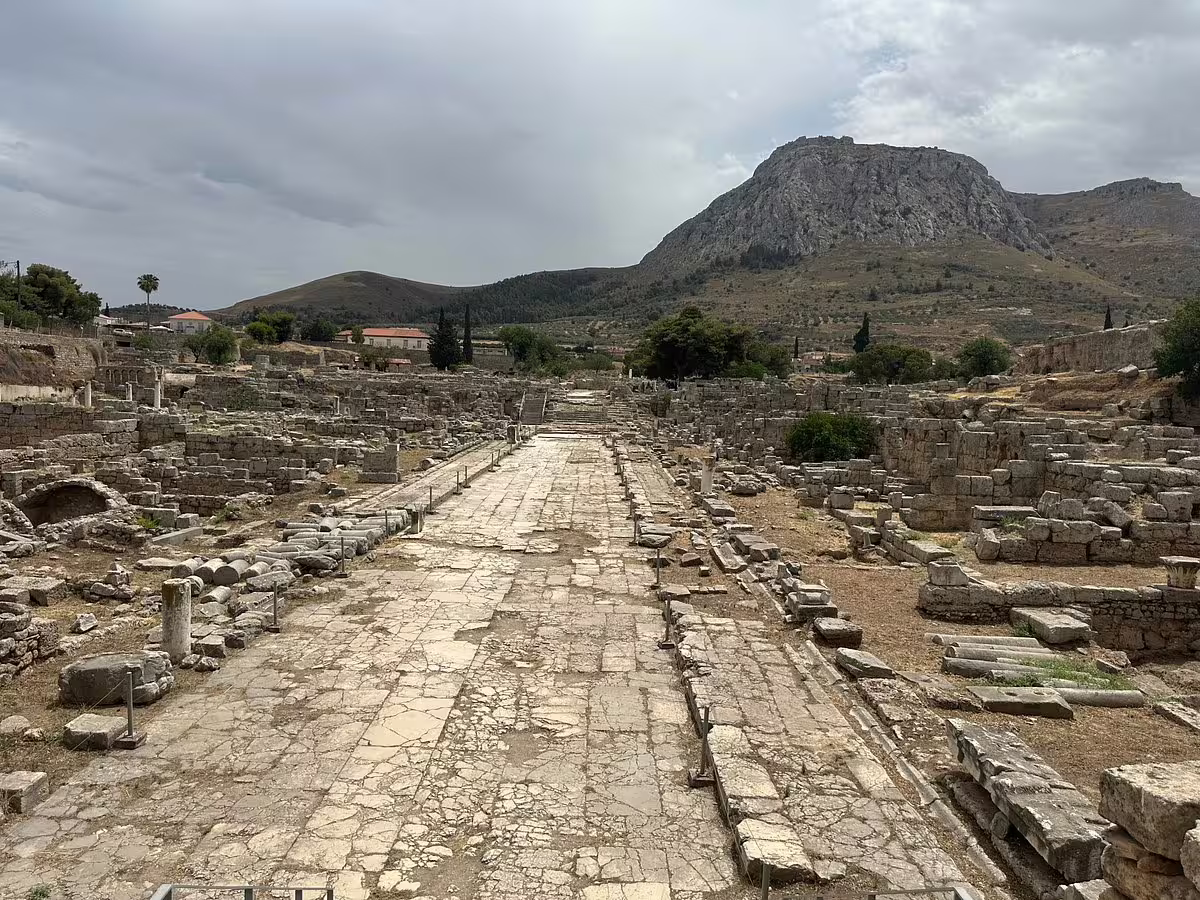 Lechaion Road in Ancient Corinth ruins with Acrocorinth hill on a private biblical tour from Athens