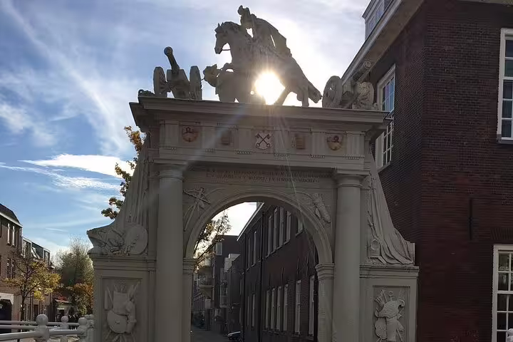 Historic Leiden city gate arch with sculptures, seen on a private guided walking tour in South Holland