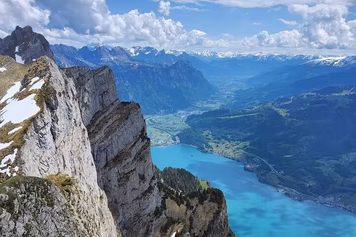 Leistkamm Ridge hike view above turquoise Walensee, steep limestone cliffs and Swiss Alps near Zurich