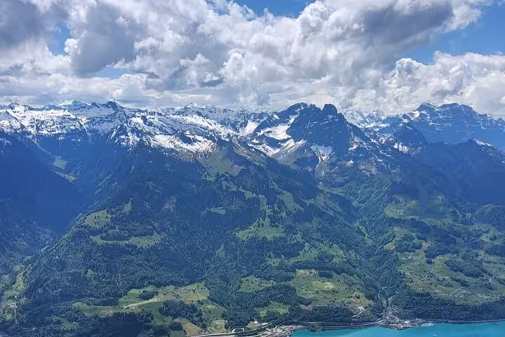 Snowy Churfirsten peaks and green valleys seen on Leistkamm Ridge hiking tour, scenic day trip from Zurich