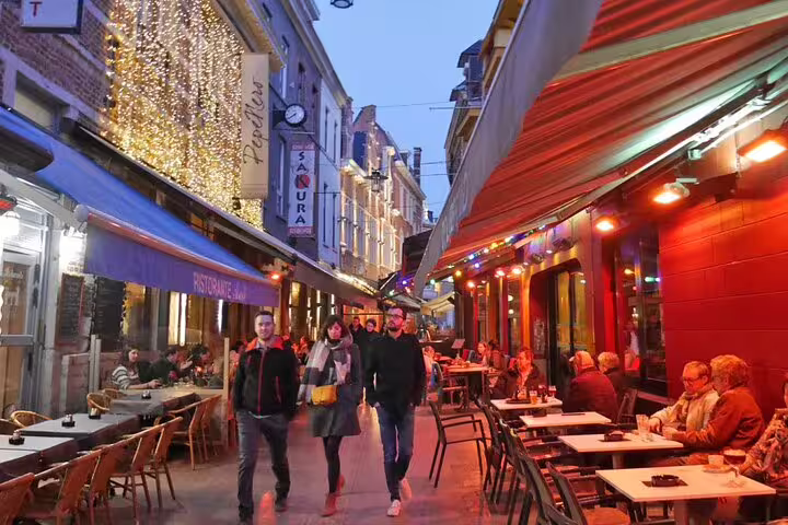Evening in Leuven’s Oude Markt with lively terraces, a fun stop on the self-guided e-Scavenger hunt walk