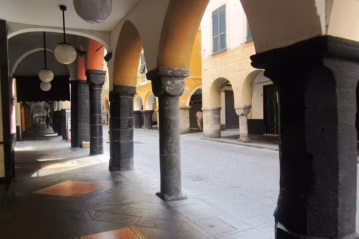 Charming arched walkway in Liguria, Italy, near Portofino and Cinque Terre, ideal for culinary exploration.