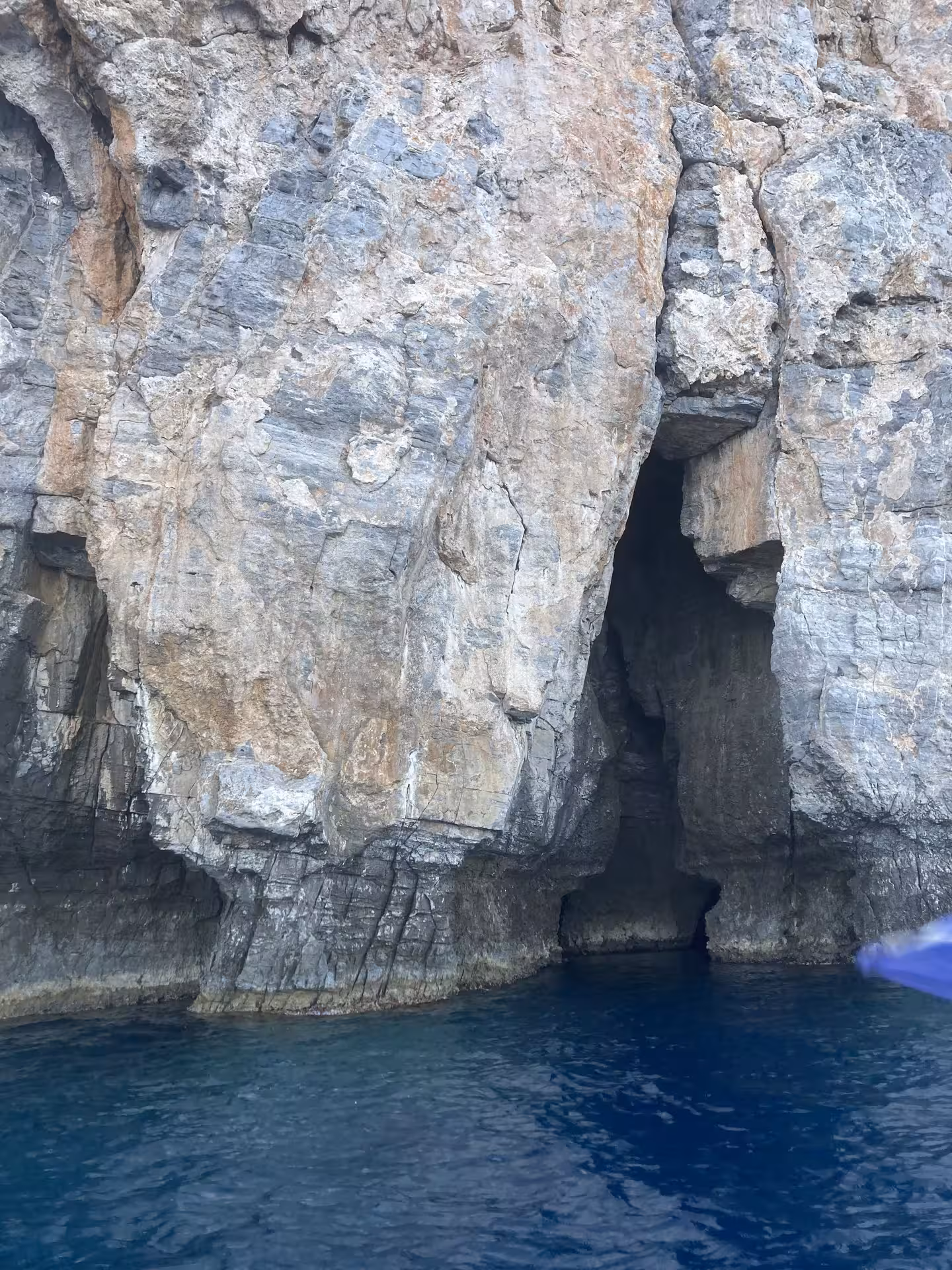 Close-up of a sea cave in Lindos cliffs with clear blue water, Axopar 25 CT Rhodes cruise stop