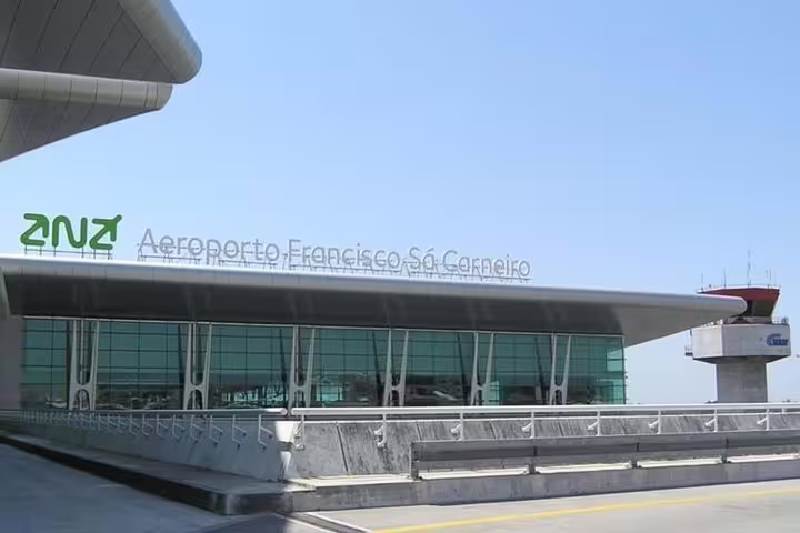 Exterior of Aeroporto Francisco Sá Carneiro, showcasing modern architecture for Lisbon Airport arrivals.