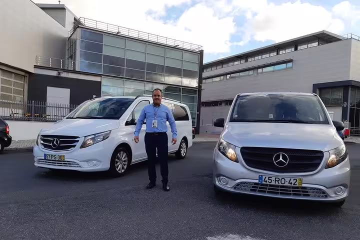 Driver with Mercedes vans at Lisbon Airport, offering comfortable transfers to Lisbon hotels.