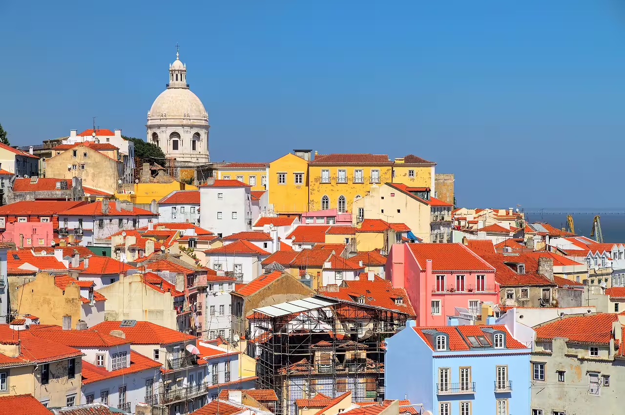 Scenic view of Lisbon's vibrant Alfama district with colorful buildings and historic architecture, perfect for a cultural city break.