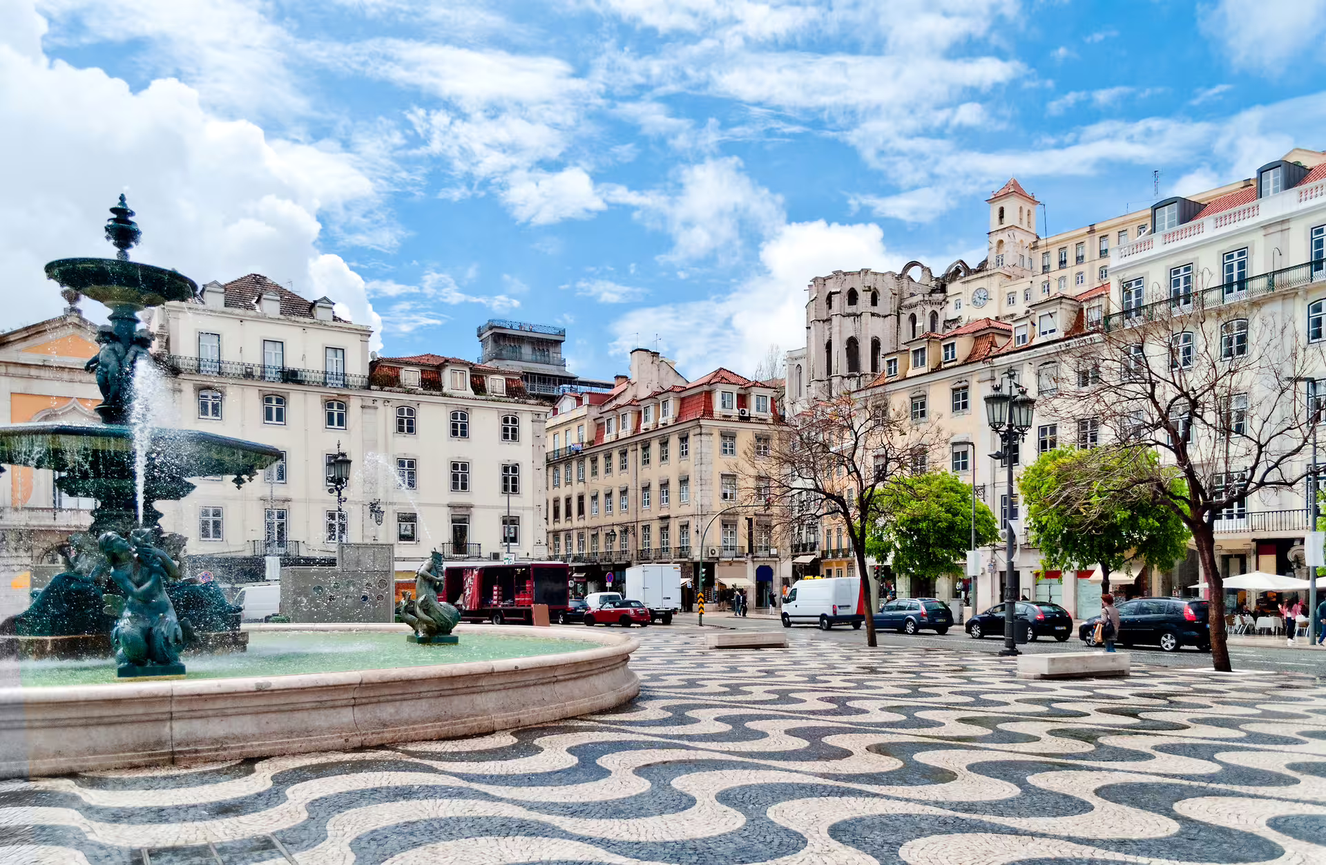 Historic Lisbon square with a beautiful fountain, surrounded by classic architecture, ideal for the Lisbon, Sintra, Estoril tour.