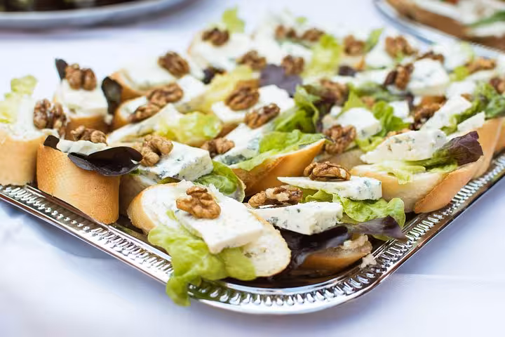 Local product tasting tray with blue cheese crostini, walnuts and fresh salad at musical aperitif concert