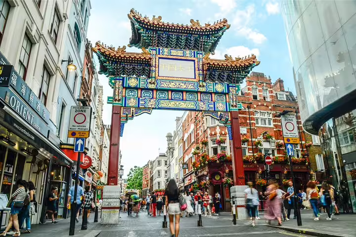 Bustling London Chinatown street scene with colorful archway, vibrant shops, and pedestrians, ideal for a private day tour.