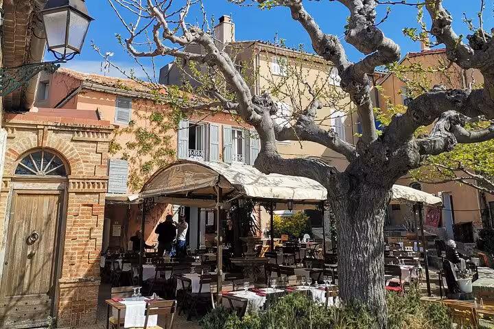 Outdoor café in a Luberon hilltop village square, Provence charm stop on South of France wine tasting tour