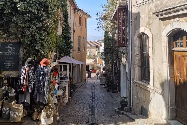 Cobblestone lane with local shops in a Luberon village, perfect stop on South of France wine tour
