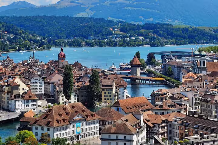 Scenic view of historic Lucerne city with Chapel Bridge and Lake Lucerne, perfect for Swiss mountain tours.