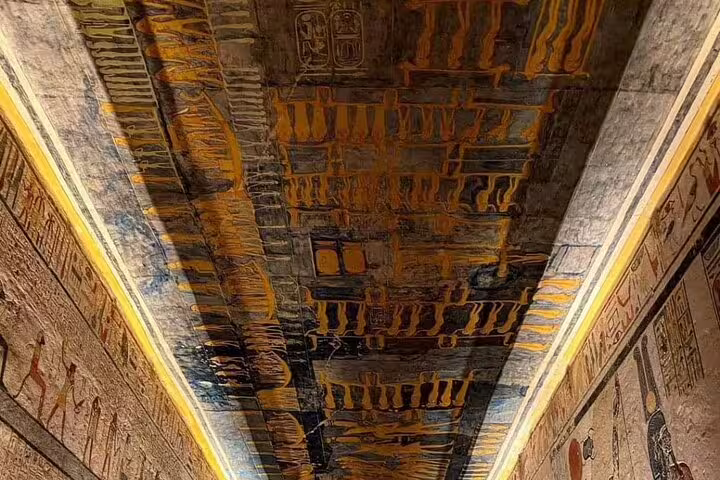 Ancient Egyptian hieroglyphs on tomb ceiling in Luxor, visited on Cairo to Luxor sleeper train tour