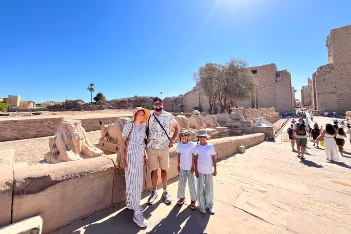 Family photo at Luxor Karnak Temple sphinx avenue on Hurghada excursion, King Tut tomb tour with lunch