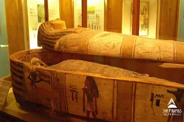 Painted ancient Egyptian sarcophagus display at Luxor Museum on half-day Luxor Mummification Museum tour