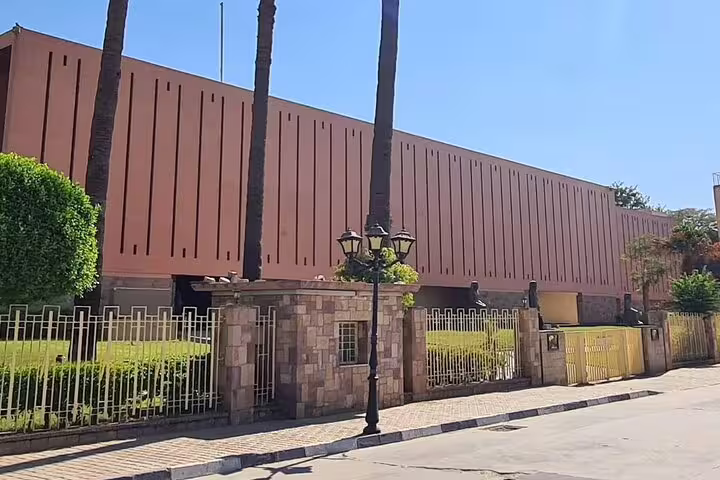 Exterior of Luxor Museum in Egypt with palm trees, meeting point for half-day Luxor and Mummification Museums tour