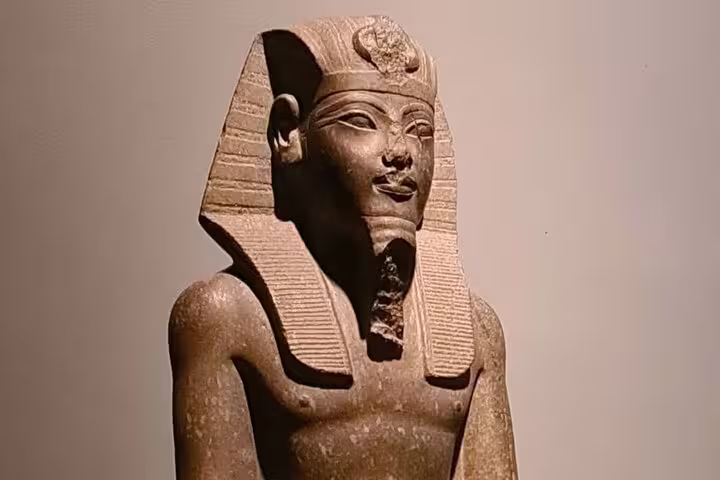 Ancient Egyptian pharaoh statue display at Luxor Museum, included in half-day Luxor and Mummification Museums tour