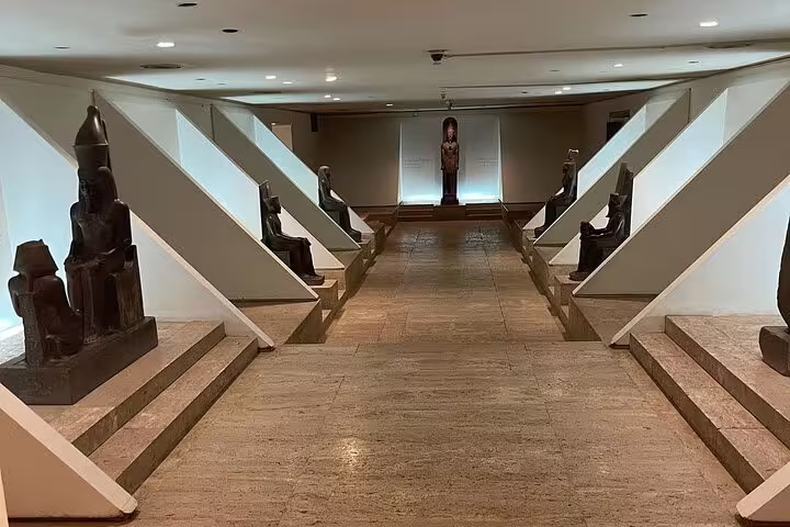 Gallery corridor with pharaonic statues inside Luxor Museum, featured on half-day Luxor and Mummification Museums tour