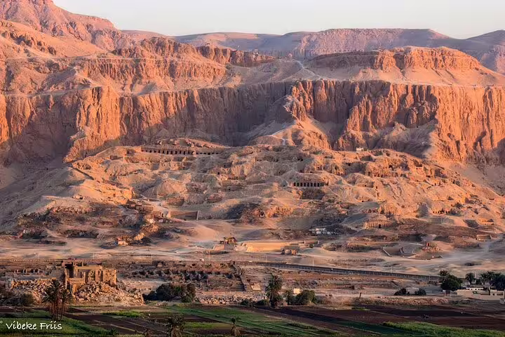 Sunrise over Luxor West Bank desert cliffs and Valley of the Kings on private sleeper train trip from Cairo