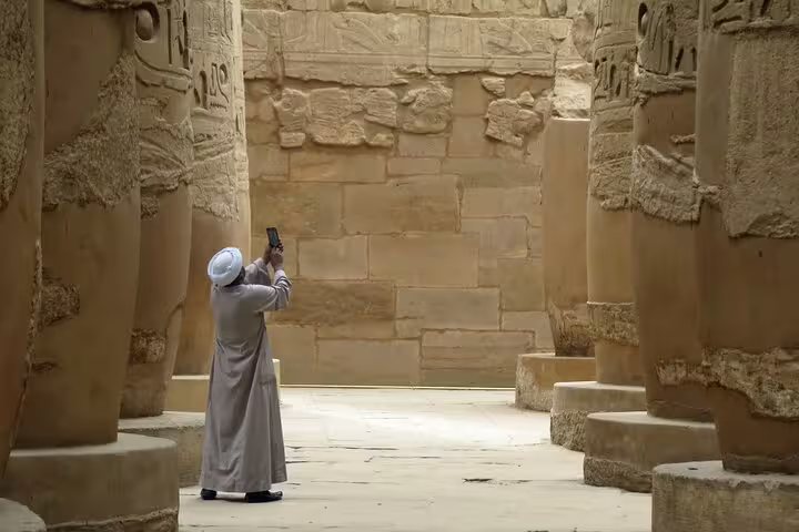 Traveler photographing towering columns at Luxor Temple, included in 4 days 3 nights Luxor to Abu Simbel short break