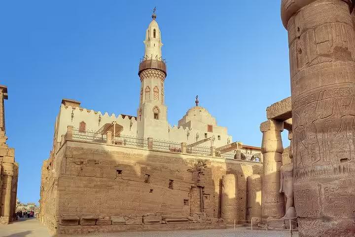 Luxor Temple ruins with mosque minaret at sunset, visited on Buy Dahabiya Nile Cruises 5 days 4 nights tour