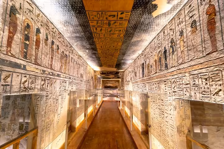 Painted hieroglyph corridor inside Luxor temple tomb, guided Cairo to Luxor day trip by flight tour