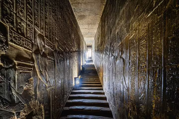 Ancient Luxor temple corridor with carved hieroglyph walls and stairs, Cairo to Luxor sleeper train 3 nights 2 days tour