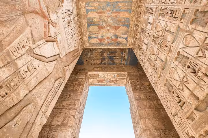 Hieroglyph-covered temple gateway and painted ceiling in Luxor, Egypt on private day tour from Hurghada