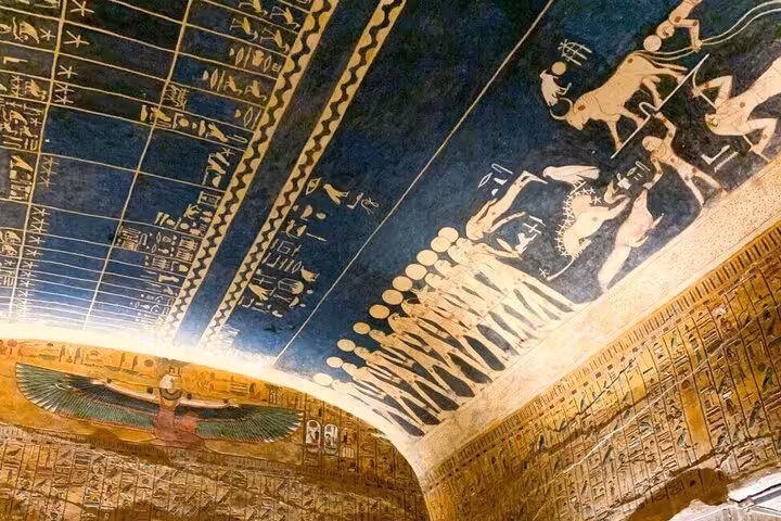 Painted ceiling with ancient Egyptian hieroglyphs inside a Luxor temple on a 6-day Nile cruise from Aswan
