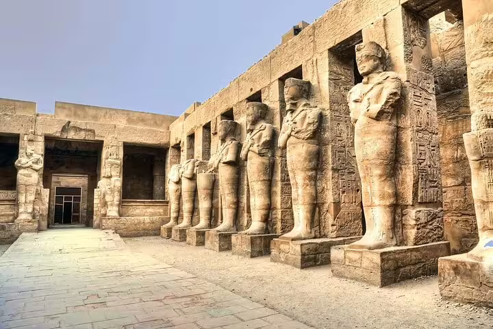 Luxor Temple avenue of standing pharaoh statues on Luxor historical day tour by bus from Hurghada