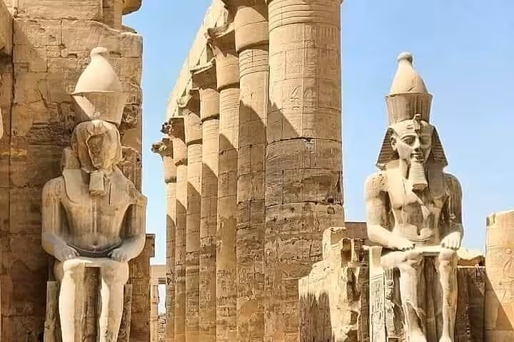 Seated pharaoh statues and towering columns at Luxor Temple, Egypt on private tour from Marsa Alam