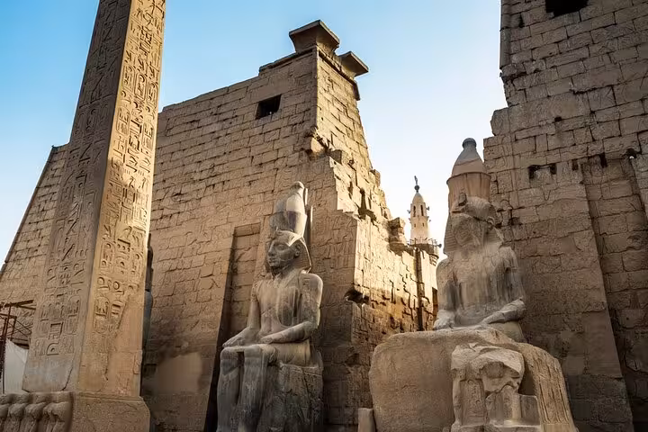 Colossal seated statues and obelisk at Luxor Temple entrance, Cairo to Luxor overday flight tour