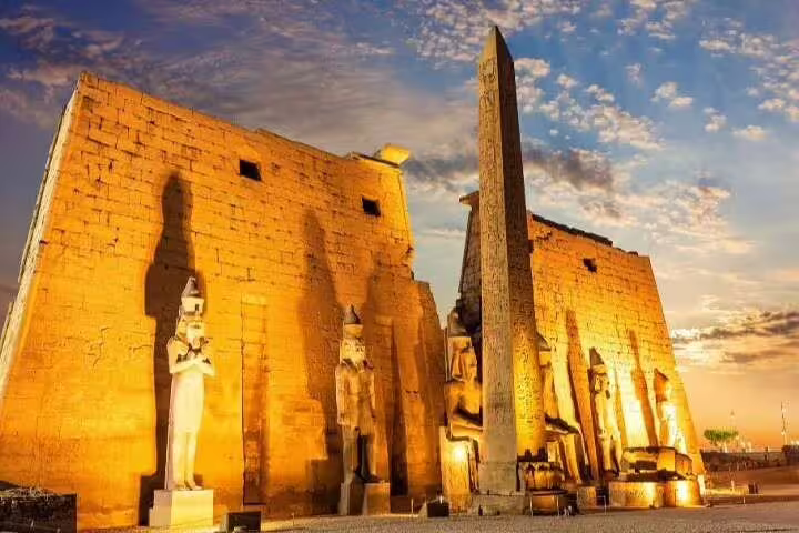 Luxor Temple at sunset with obelisk and statues, evening visit on 3 nights Nile cruise from Aswan package