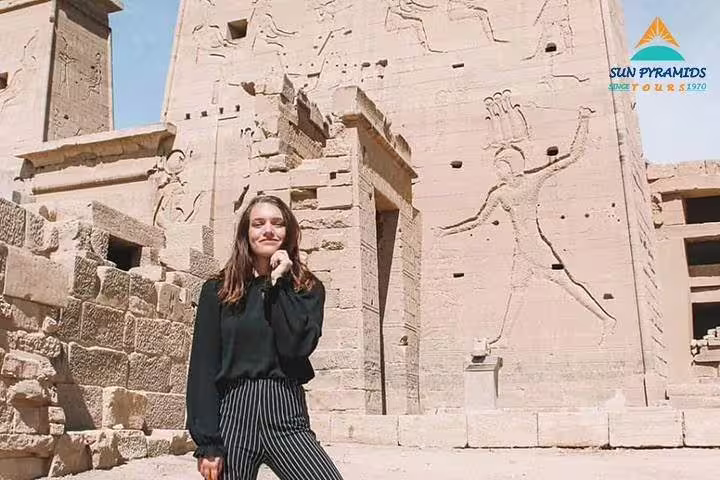Visitor at Luxor Temple wall carvings on a 2-day Cairo and Luxor excursion from Hurghada, Egypt tour