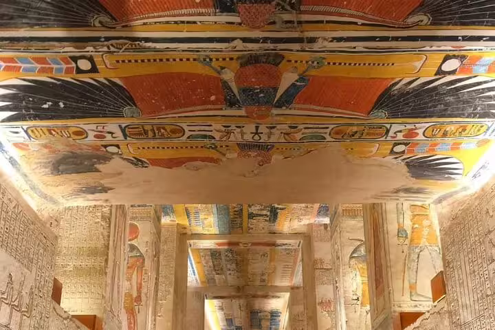 Painted tomb ceiling and hieroglyph corridors in Luxor on private sleeper train trip from Cairo