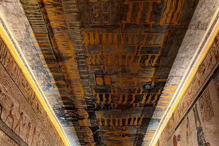Close-up of ancient Egyptian painted ceiling with hieroglyphic bands in Luxor tomb, Cairo to Luxor sleeper train tour