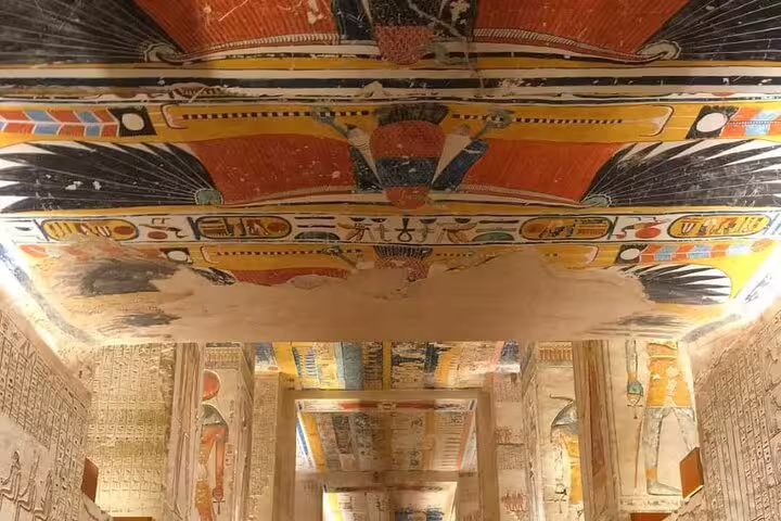 Colorful tomb ceiling and hieroglyph corridors in Luxor Valley of the Kings on Cairo sleeper train trip
